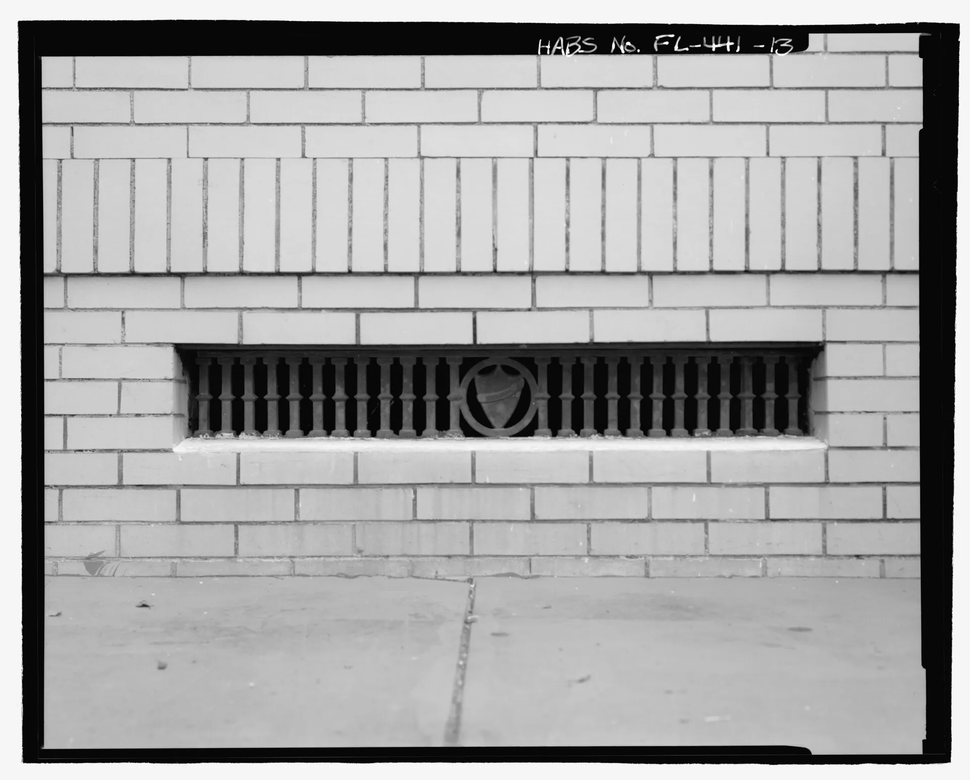 A foundation vent set into a brick wall, photographed for the Historic American Buildings Survey