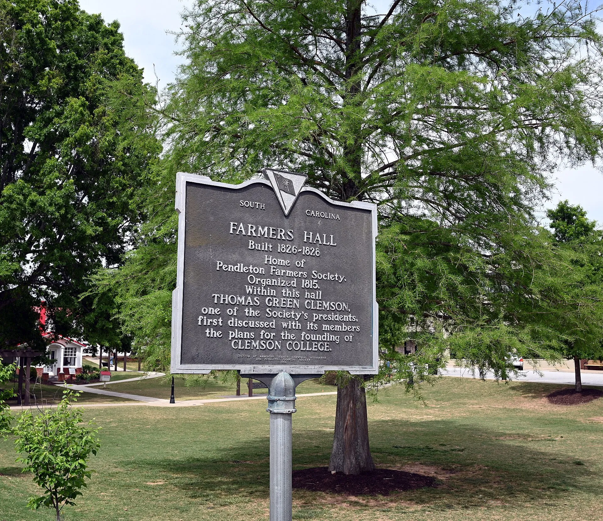 The South Carolina historical marker for Farmers Hall in Pendleton, built 1826 to 1828, standing on the town green under a large tree