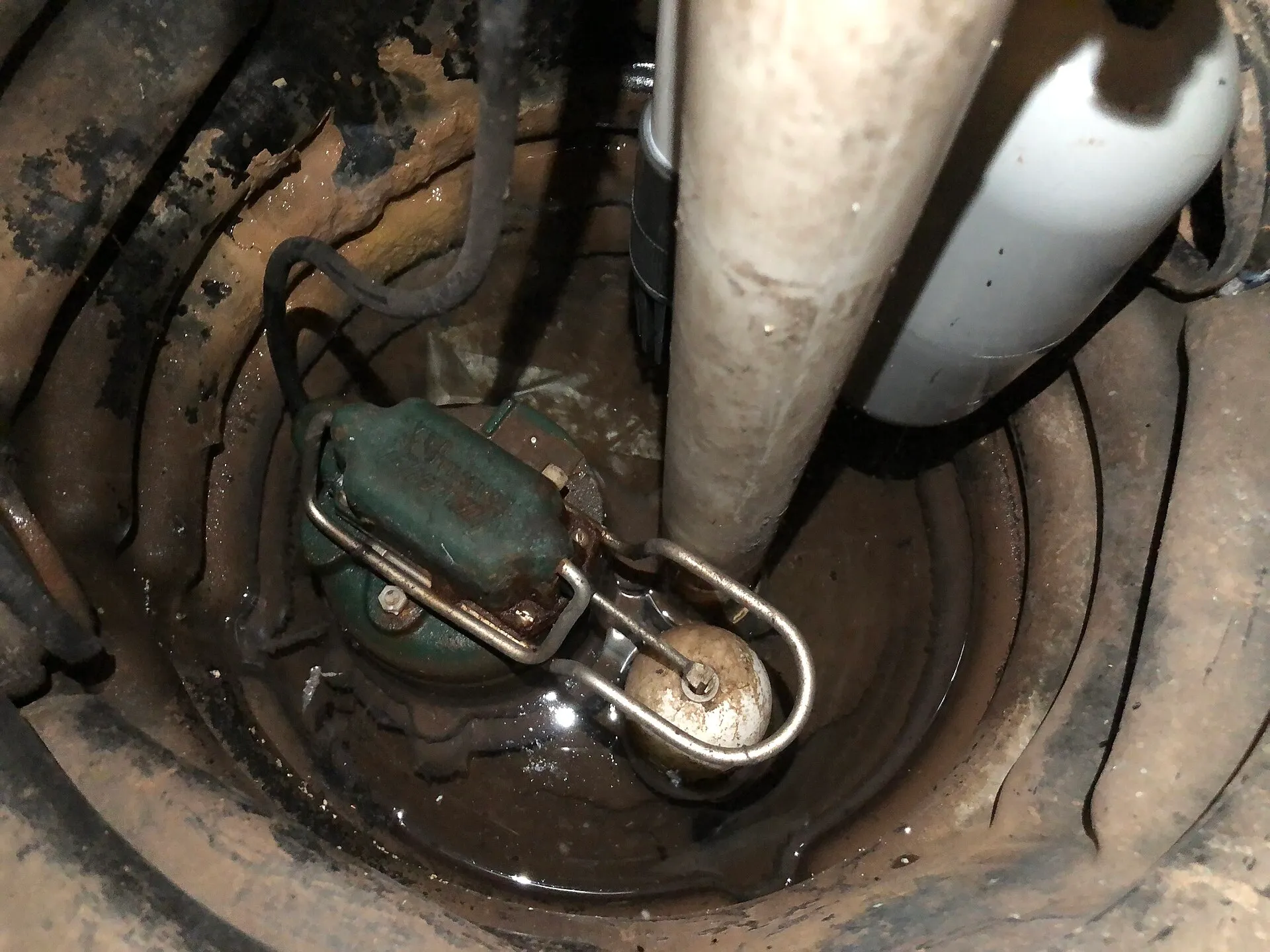 A newly installed sump pump in its pit